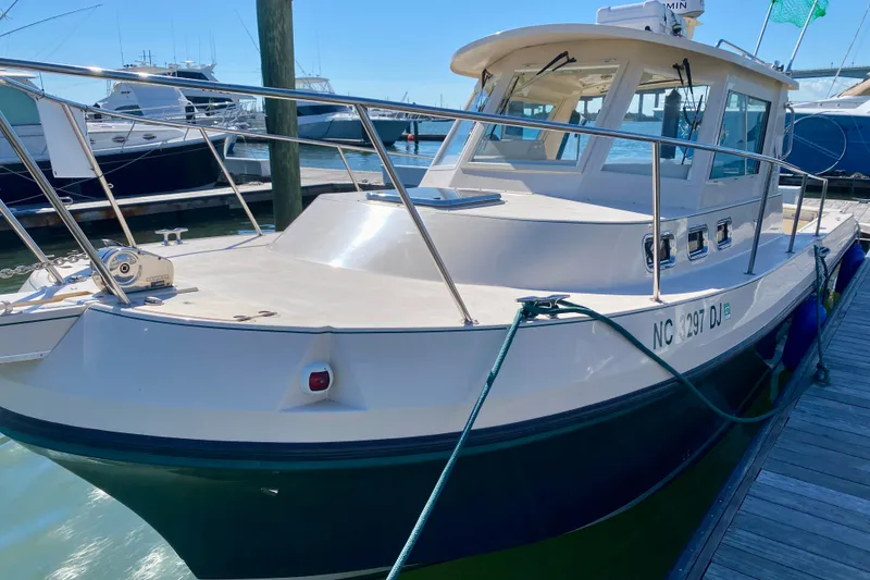 Slide: The Image of 2008 Albin 28 Tournament Express boat docked at marina under clear blue sky. - 6