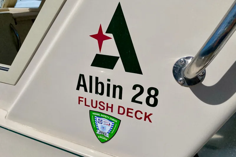 Slide: The Image of 2008 Albin 28 Tournament Express boat with flush deck and safety check sticker. - 10