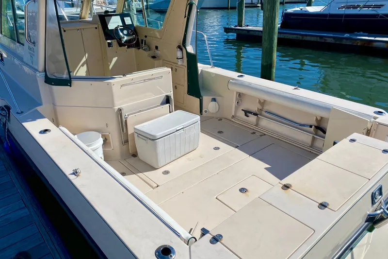 Slide: The Image of 2008 Albin 28 Tournament Express boat with spacious deck and seating at marina. - 8