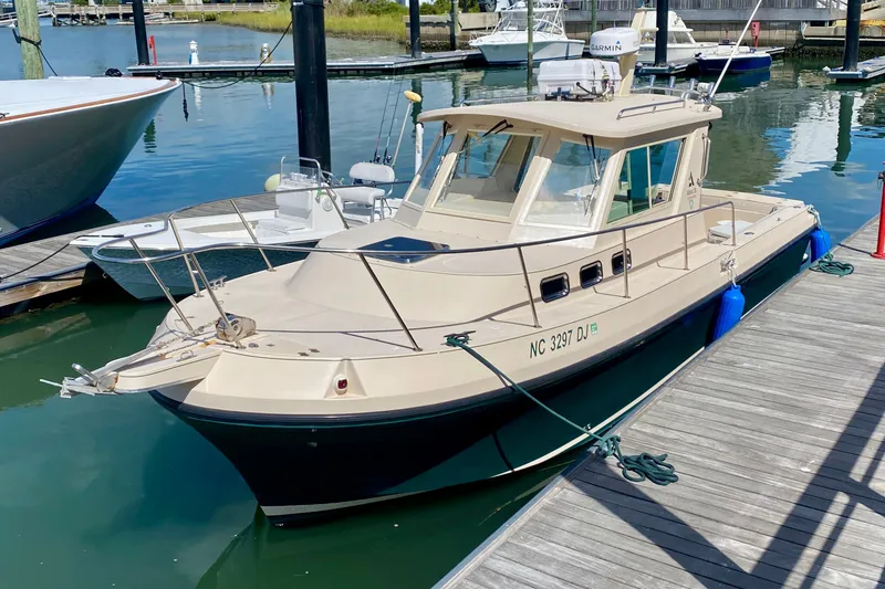 Slide: The Image of 2008 Albin 28 Tournament Express docked at a marina, featuring a sleek design. - 2