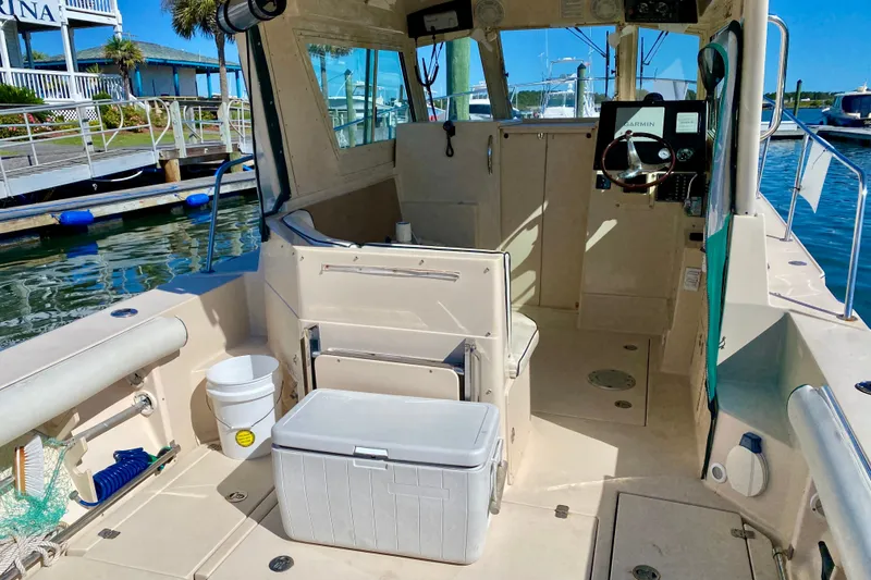 Slide: The Image of 2008 Albin 28 Tournament Express boat interior at marina, featuring helm and seating area. - 9