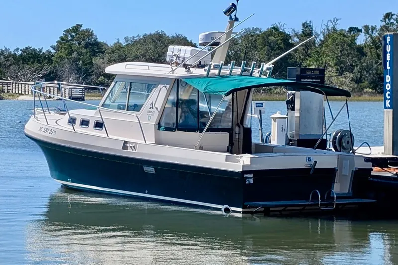 Slide: The Image of 2008 Albin 28 Tournament Express boat docked at a fuel station. - 15