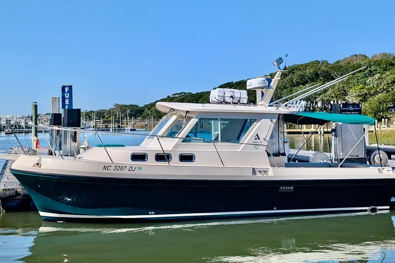 Slide: The Image of 2008 Albin 28 Tournament Express boat docked at marina with clear blue sky. - 16