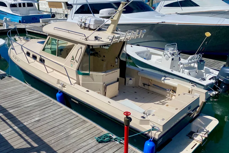 Slide: The Image of 2008 Albin 28 Tournament Express docked at marina, featuring spacious deck and cabin. - 3