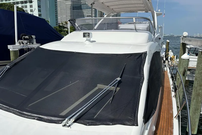Slide: The Image of 2013 Azimut Fly 53 yacht docked, featuring sleek design and spacious deck. - 51