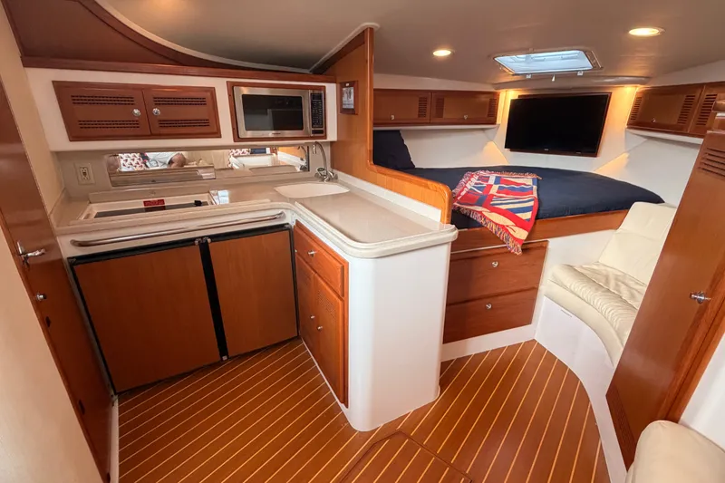Slide: The Image of Luxurious interior of a 2003 Cabo 35 Express yacht with kitchen and cozy sleeping area. - 41