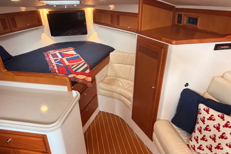 Slide: The Image of Interior of 2003 Cabo 35 Express yacht with cozy cabin and nautical decor. - 43
