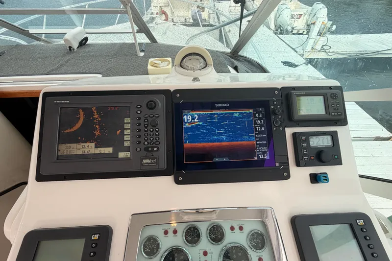 Slide: The Image of Helm of 2003 Cabo 35 Express with navigation and control instruments. - 24
