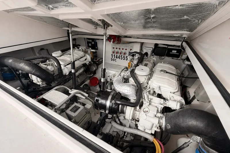Slide: The Image of Engine room of a 2003 Cabo 35 Express boat, showcasing dual engines and mechanical components. - 50