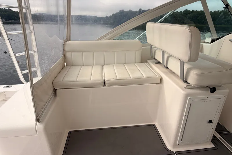 Slide: The Image of 2003 Cabo 35 Express boat interior with white seating and lake view. - 29