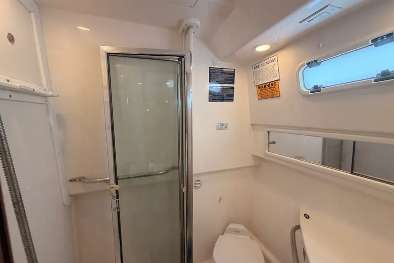 Slide: The Image of Bathroom interior of 2003 Cabo 35 Express boat with shower and toilet. - 36
