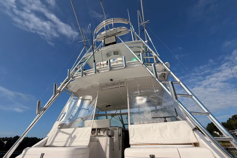 Slide: The Image of 2003 Cabo 35 Express boat with tower against a clear blue sky. - 15