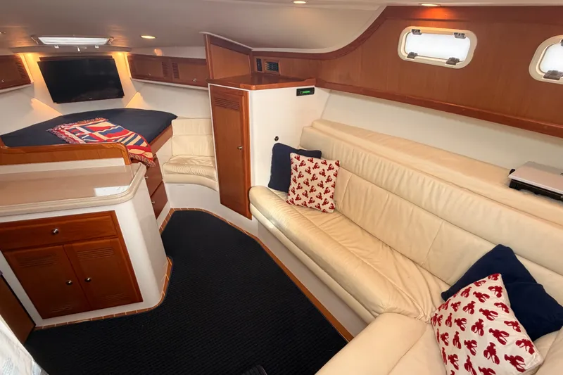 Slide: The Image of Interior of 2003 Cabo 35 Express yacht with cozy seating and nautical decor. - 39