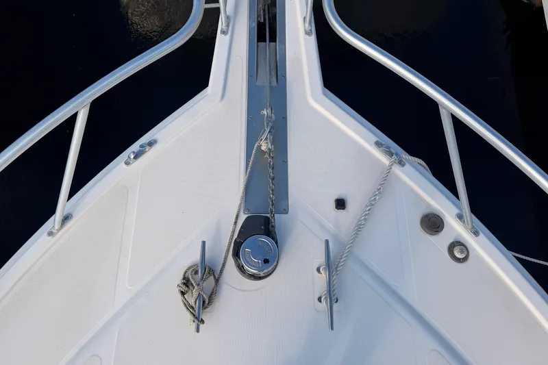 Slide: The Image of Bow of 2003 Cabo 35 Express boat with anchor and cleats. - 13
