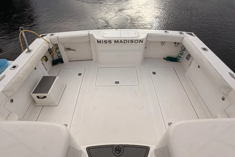Slide: The Image of 2003 Cabo 35 Express boat deck, labeled "Miss Madison," with clean, spacious layout. - 16