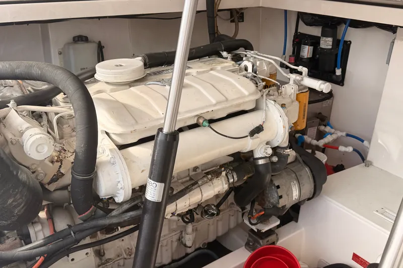 Slide: The Image of Engine compartment of a 2003 Cabo 35 Express boat, showcasing mechanical components and wiring. - 53