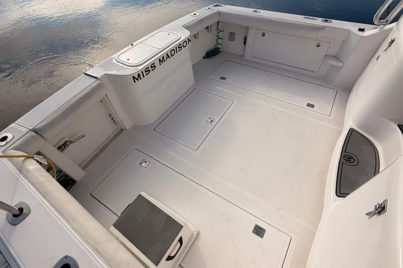 Slide: The Image of 2003 Cabo 35 Express boat deck, spacious and clean, named "Miss Madison." - 19