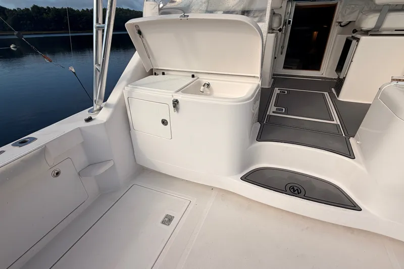 Slide: The Image of 2003 Cabo 35 Express boat interior with open storage compartment and sleek design. - 20
