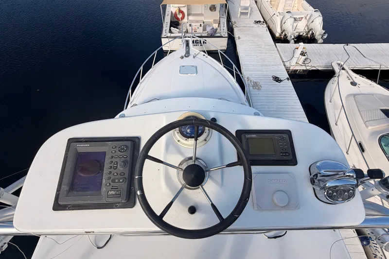 Slide: The Image of Helm of 2003 Cabo 35 Express boat with navigation equipment and steering wheel. - 14