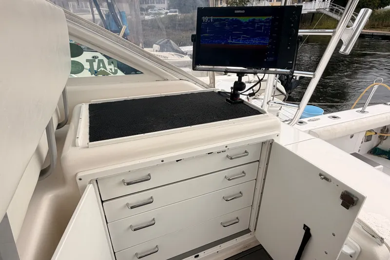 Slide: The Image of 2003 Cabo 35 Express boat interior with navigation equipment and storage drawers. - 31