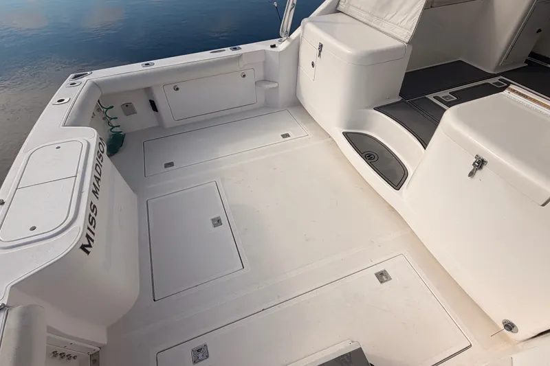 Slide: The Image of 2003 Cabo 35 Express boat deck with storage compartments and seating. - 18