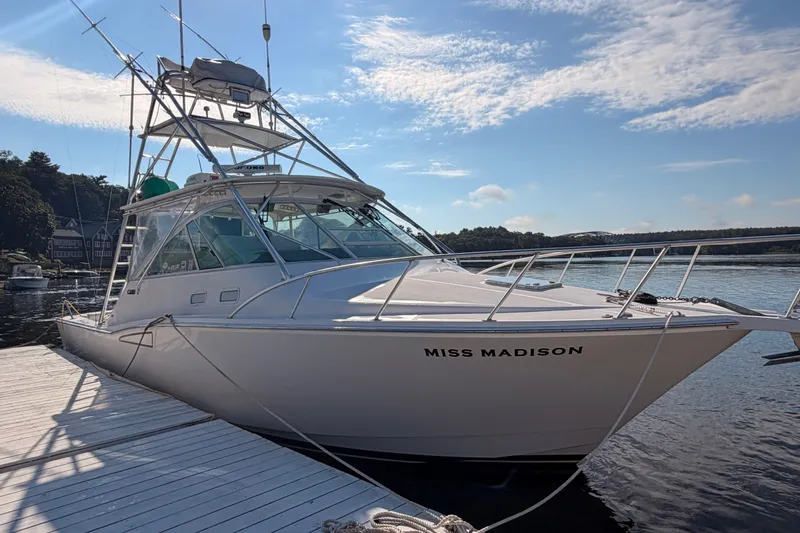 Slide: The Image of 2003 Cabo 35 Express boat named "Miss Madison" docked on a sunny day. - 4
