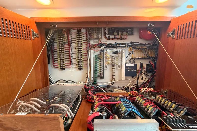 Slide: The Image of Electrical panel inside a 2003 Cabo 35 Express boat, showcasing wiring and components. - 34