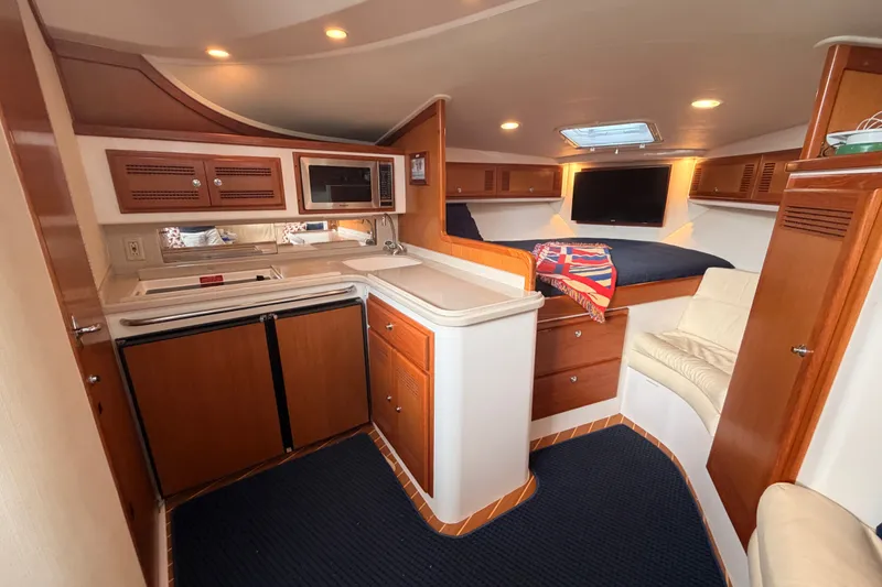 Slide: The Image of Luxurious interior of a 2003 Cabo 35 Express yacht with kitchenette and cozy seating. - 44