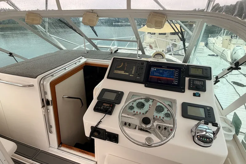 Slide: The Image of Helm of 2003 Cabo 35 Express boat with navigation instruments and steering wheel. - 22