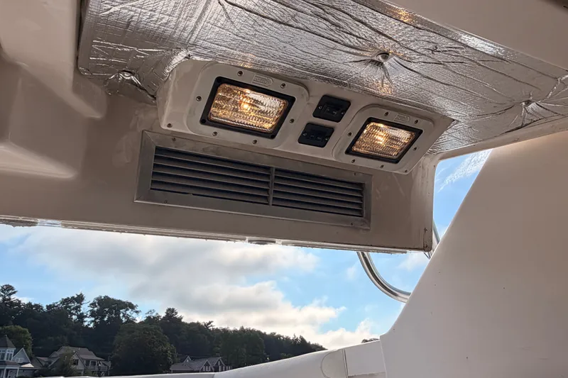 Slide: The Image of Ceiling lights and vent on a 2003 Cabo 35 Express boat interior. - 49