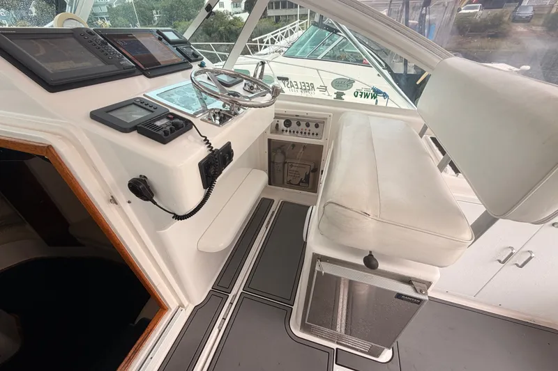 Slide: The Image of Cockpit of 2003 Cabo 35 Express boat with steering wheel and navigation equipment. - 23