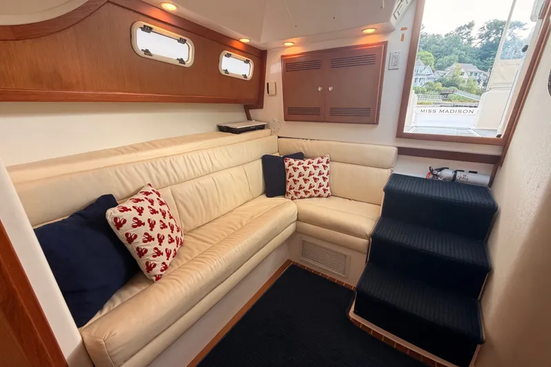 Slide: The Image of Luxurious interior of 2003 Cabo 35 Express yacht with cream leather seating and nautical decor. - 38