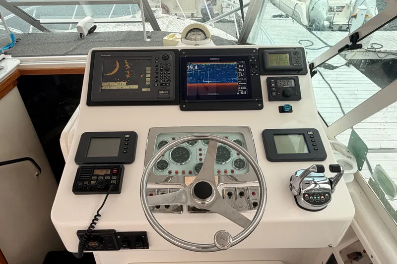 Slide: The Image of Control panel of a 2003 Cabo 35 Express boat with navigation instruments. - 9
