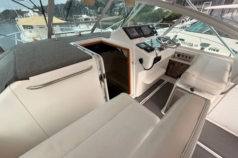 Slide: The Image of 2003 Cabo 35 Express boat interior with helm, seating, and navigation equipment. - 25