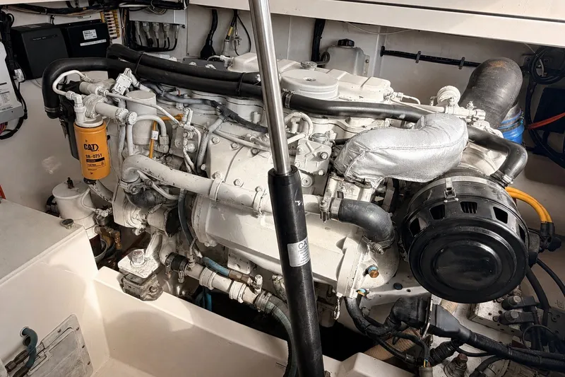 Slide: The Image of Engine room of a 2003 Cabo 35 Express boat, featuring a well-maintained marine engine. - 51