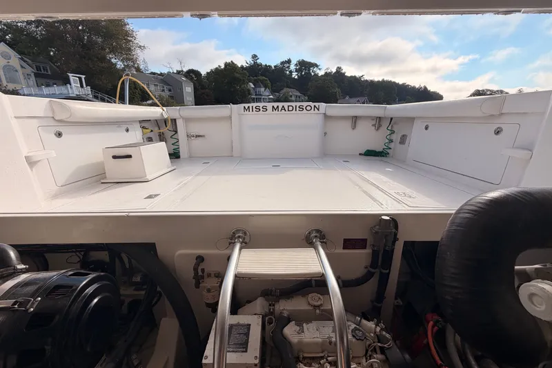 Slide: The Image of 2003 Cabo 35 Express boat deck with engine view, labeled "Miss Madison." - 47
