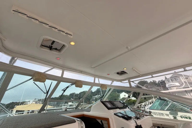 Slide: The Image of Interior view of a 2003 Cabo 35 Express boat cockpit with navigation equipment. - 32
