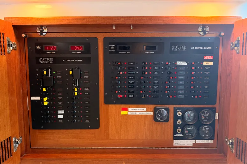 Slide: The Image of Electrical control panel of a 2003 Cabo 35 Express yacht, featuring AC and DC systems. - 33