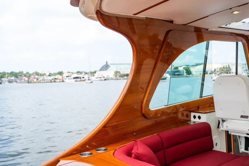 Slide: The Image of Interior of 2020 Hinckley Picnic Boat 37 MKIII with wooden finish and red seating. - 15