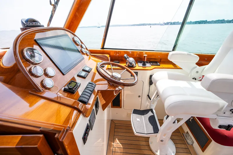 Slide: The Image of Helm of 2020 Hinckley Picnic Boat 37 MKIII with wooden dashboard and white captain's chair. - 22
