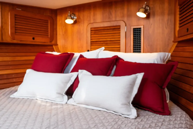 Slide: The Image of Cozy cabin interior of 2020 Hinckley Picnic Boat 37 MKIII with red and white pillows. - 43