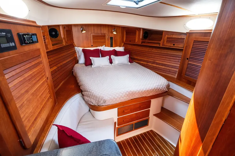 Slide: The Image of Luxurious cabin interior of 2020 Hinckley Picnic Boat 37 MKIII with wood finish and cozy bedding. - 41