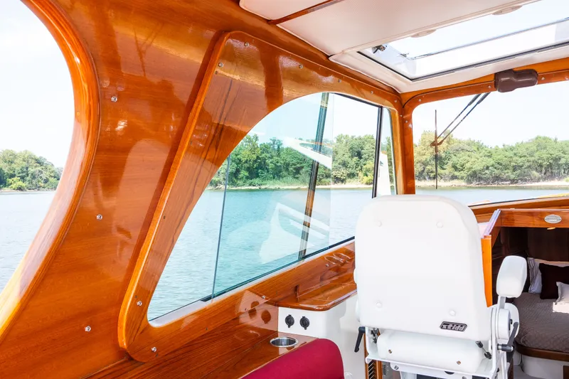 Slide: The Image of Interior of 2020 Hinckley Picnic Boat 37 MKIII with polished wood and scenic water view. - 19