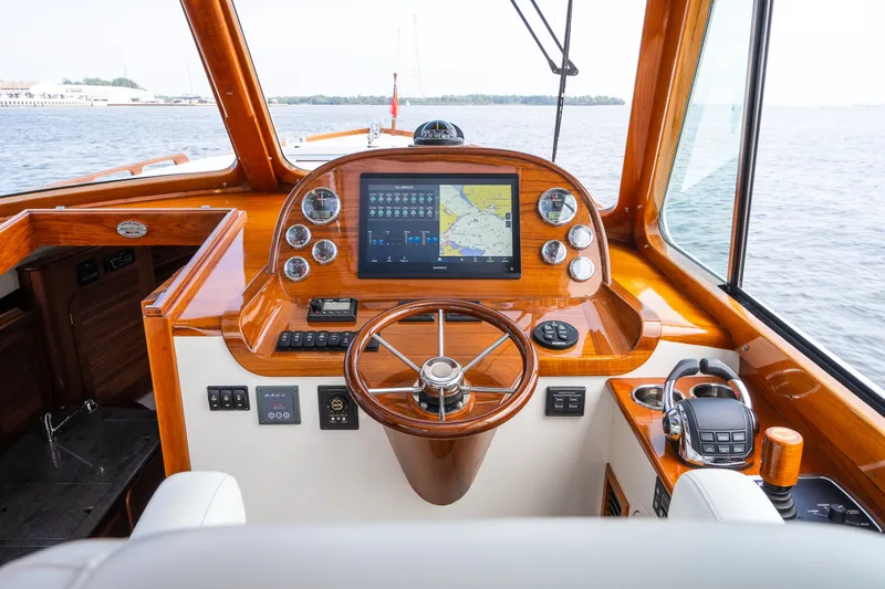 Slide: The Image of Helm of 2020 Hinckley Picnic Boat 37 MKIII with navigation display and wooden steering wheel. - 24