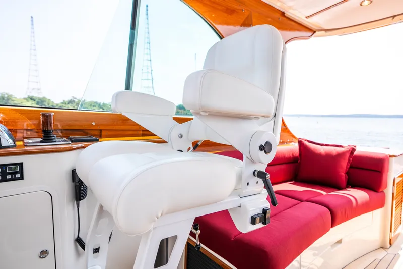 Slide: The Image of Luxurious interior of 2020 Hinckley Picnic Boat 37 MKIII with white helm seat and red sofa. - 20