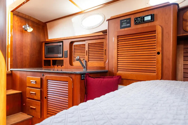 Slide: The Image of Interior of 2020 Hinckley Picnic Boat 37 MKIII with wooden cabinetry and modern amenities. - 44