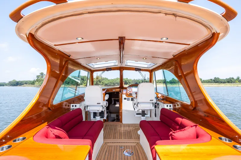 Slide: The Image of Interior of 2020 Hinckley Picnic Boat 37 MKIII with red seating and wooden finishes. - 17