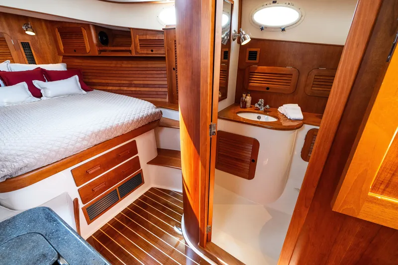 Slide: The Image of Luxurious cabin interior of 2020 Hinckley Picnic Boat 37 MKIII with wood finishes and cozy bed. - 46