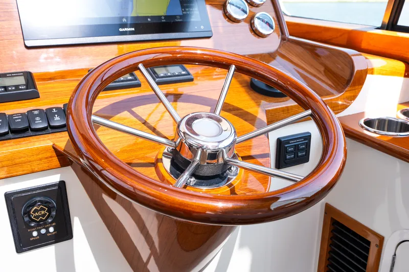 Slide: The Image of Steering wheel of 2020 Hinckley Picnic Boat 37 MKIII with polished wood finish. - 27