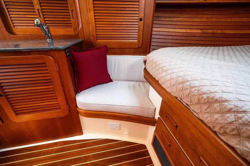 Slide: The Image of Luxurious cabin interior of 2020 Hinckley Picnic Boat 37 MKIII with wood finish and cozy seating. - 45